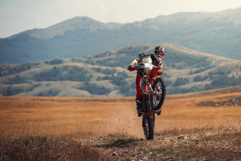 Rider doing a wheelie on an open plateau