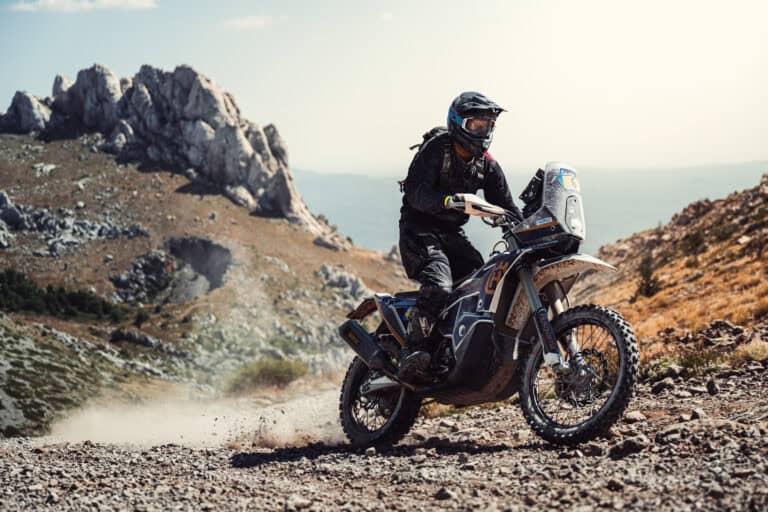 Rider on a rally bike on a rocky mountain track