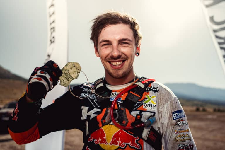 Smiling rider showing his finisher medal