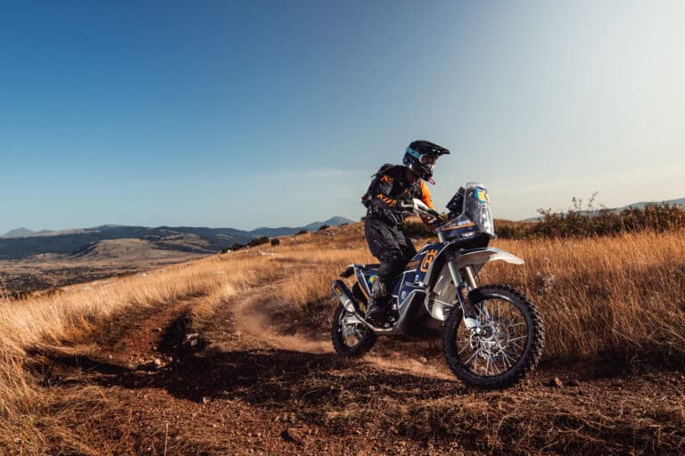 Rider on an adventure bike crossing a dry plateau