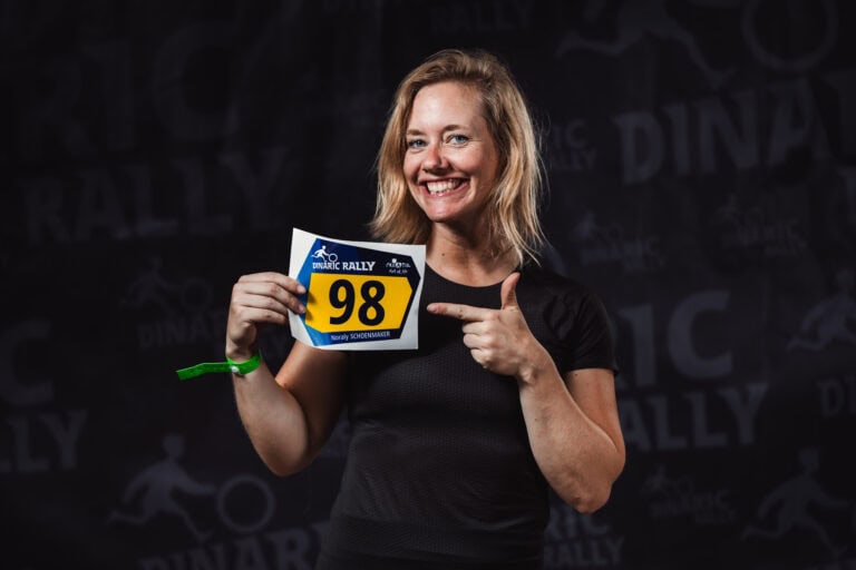 Smiling woman showing race number 98