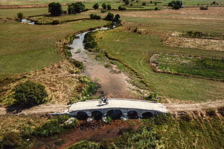 Aerial view of a stream crossing on a green plateau