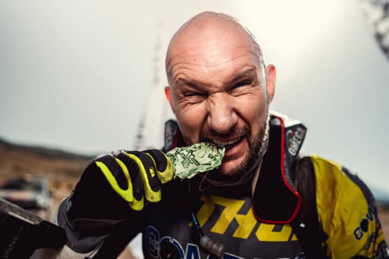 Rider biting his stone finisher medal