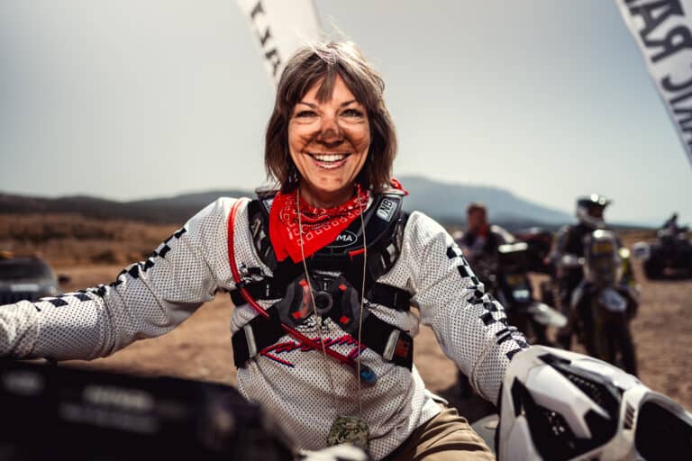 Smiling female rider in race gear at the finish
