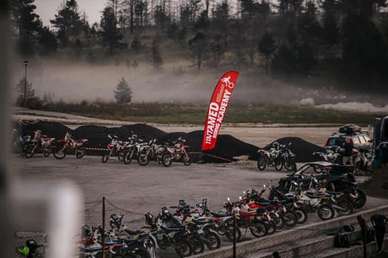 Rally bikes lined up in the morning haze at the start