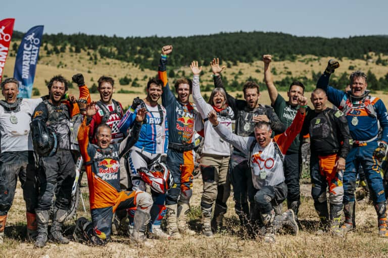 Group photo of riders and crew in the bivouac